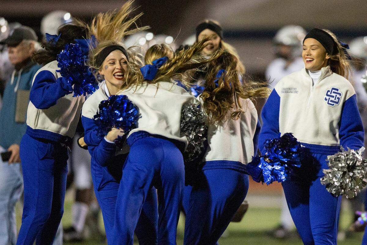 Ocean Springs cheerleaders celebrate after Ocean Springs won a 6A playoff game against Oak Grove at Greyhound Stadium in Ocean Springs on Friday, Nov. 18, 2022.