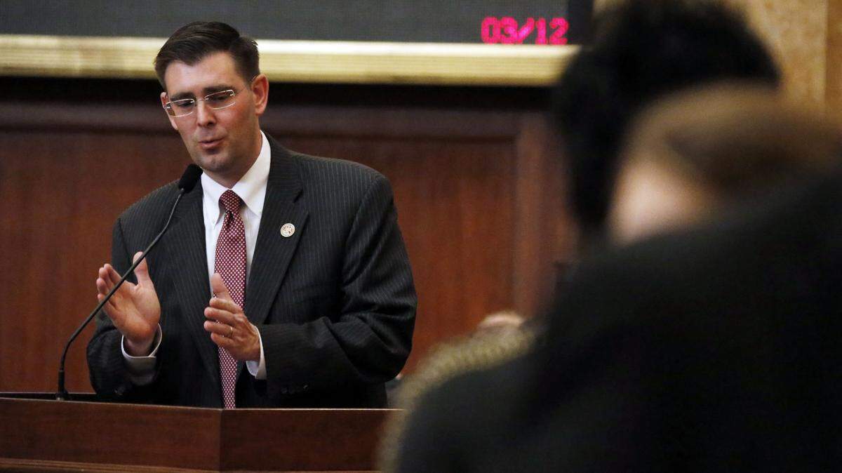 House Judiciary Committee B chairman Andy Gipson, R-Braxton, explains the intent of the Mississippi Religious Freedom Restoration Act to Rep. Adrienne Wooten, D-Jackson, in House chambers at the Capitol in Jackson, Miss., Wednesday, March 12, 2014. The House passed Senate Bill 2681 by an 80-37 vote after it had been amended to call for a study panel of the combined House and Senate Judiciary committees. Another prong that inserts the phrase "In God We Trust" into the state seal passed intact. (AP Photo/Rogelio V. Solis)