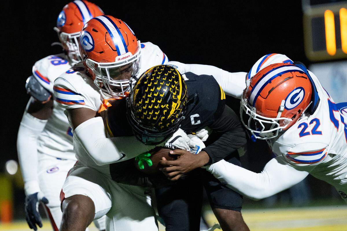D’Iberville quarterback Jordan Walley (3) is sacked by several Gulfport defenders Friday in the Warriors’ loss to the Admirals.