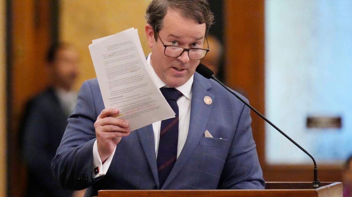 Mississippi State Rep. Fred Shanks, R-Brandon, waves a copy of his proposed resolution that would allow Mississippi residents to put policy proposals on statewide ballots, except for abortion and a few other issues, Wednesday, Jan. 24, 2024, at the Mississippi State Capitol in Jackson. The Republican-dominated House approved the resolution in an 80-36 vote.(AP Photo/Rogelio V. Solis)