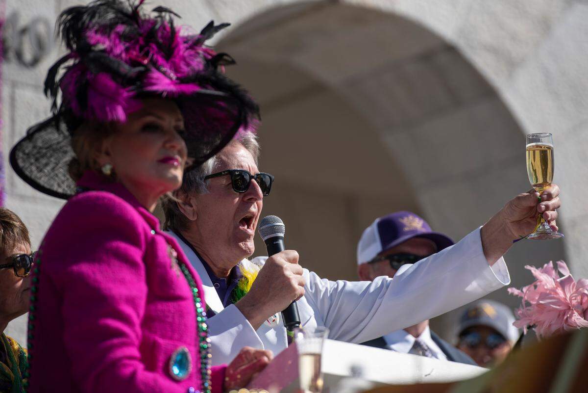 Mayor Andrew “Fofo” Glitch toasts to King d’Iberville during the Gulf Coast Carnival Association’s Mardi Gras parade in Biloxi on Tuesday, Feb. 13, 2024.
