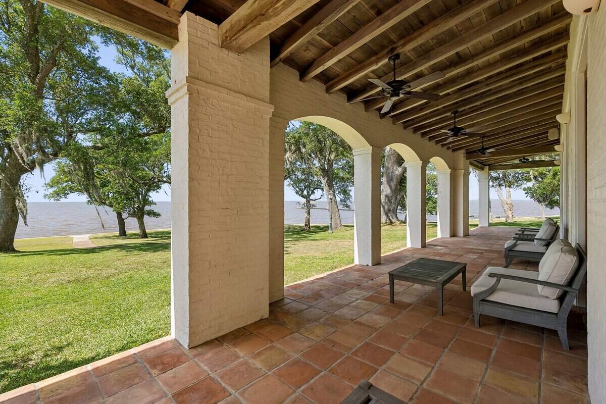 A veranda overlooking the Mississippi Sound is one of many stunning features of a luxury property on the market in Ocean Springs for $7 million. The property encompasses 93 acres and includes a second Acadian-style home.