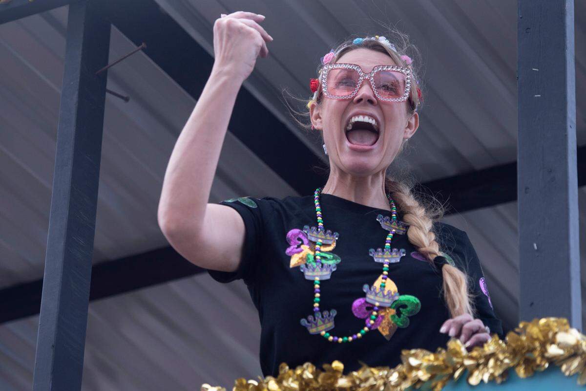 A float rider throws beads to the crowd during the Gulf Coast Carnival Association Mardi Gras parade in Biloxi on Tuesday, March 4, 2025.