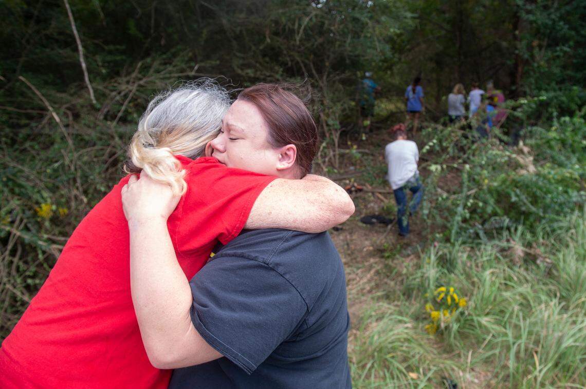 A friend whose daughter attended school with Baleigh Bowlin and Chloe Taylor with hugs the grandmother of one of the girls outside the site of where a car accident resulted in the death of both girls on Highway 613 in Hurley on Monday, Oct. 17, 2022.