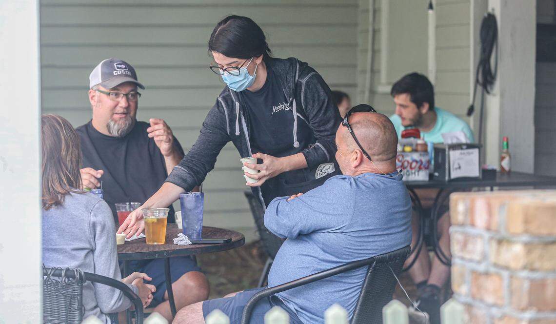 A Murky Waters waitress served customers on their patio in May 2020.
