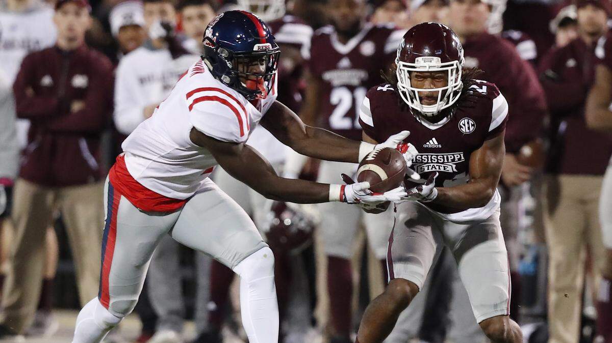Ole Miss wide receiver A.J. Brown, left, reaches for a first-down pass in front of Mississippi State defensive back Chris Rayford (24) on Nov. 23, 2017, in Starkville.