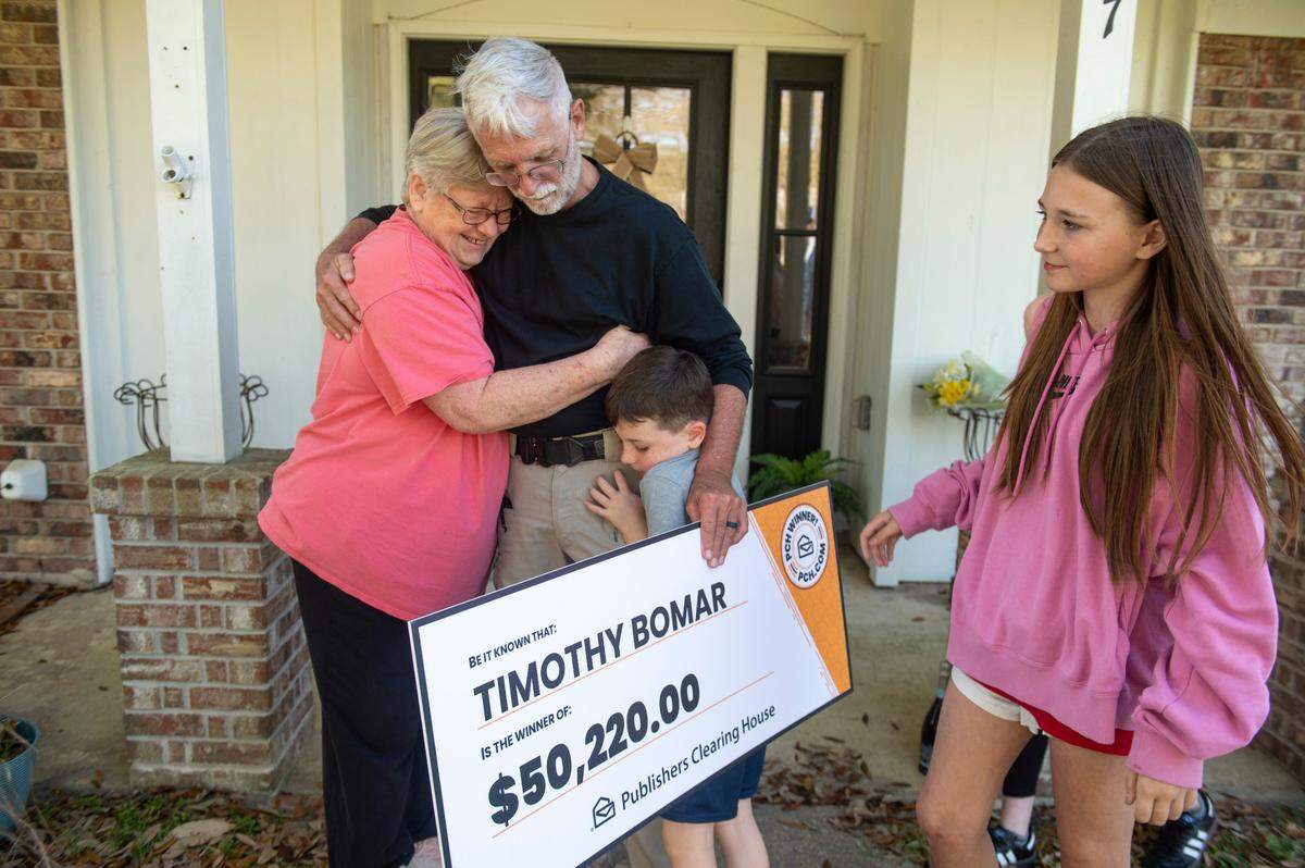 Publishers Clearing House prize winner Timothy Bomar and his wife Sandra hug their grandkids after receiving a $50k prize on Wednesday, March 19, 2025.