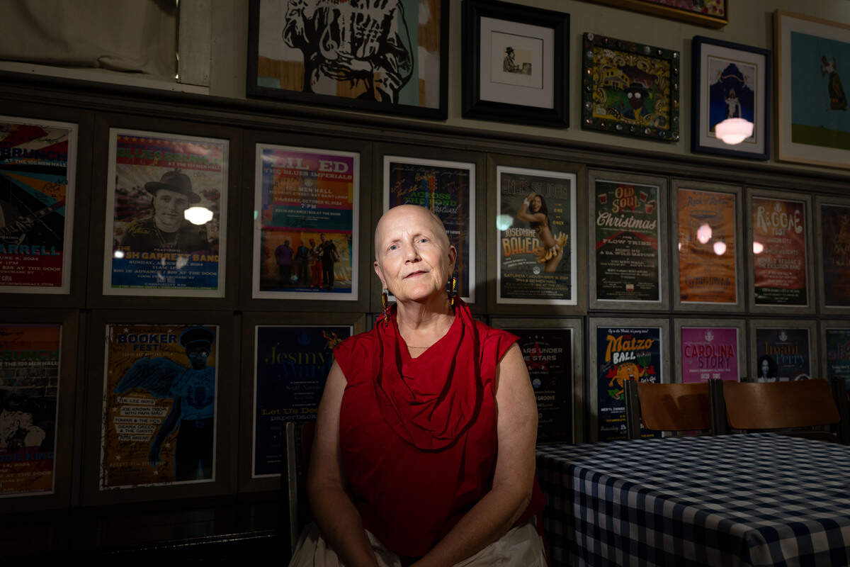 Rachel Dangermond poses for a portrait in front of a series of artwork and posters for artists who have previously performed at the 100 Men Hall in Bay St. Louis on Tuesday, June 16, 2026.