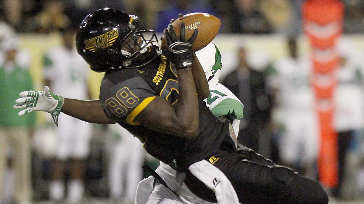 TIM ISBELL/SUN HERALD 
 Southern Miss receiver Mike Thomas catches a deep pass over North Texas defensive back James Gray, Saturday, Oct. 3, 2015. The play set up USM's third touchdown.