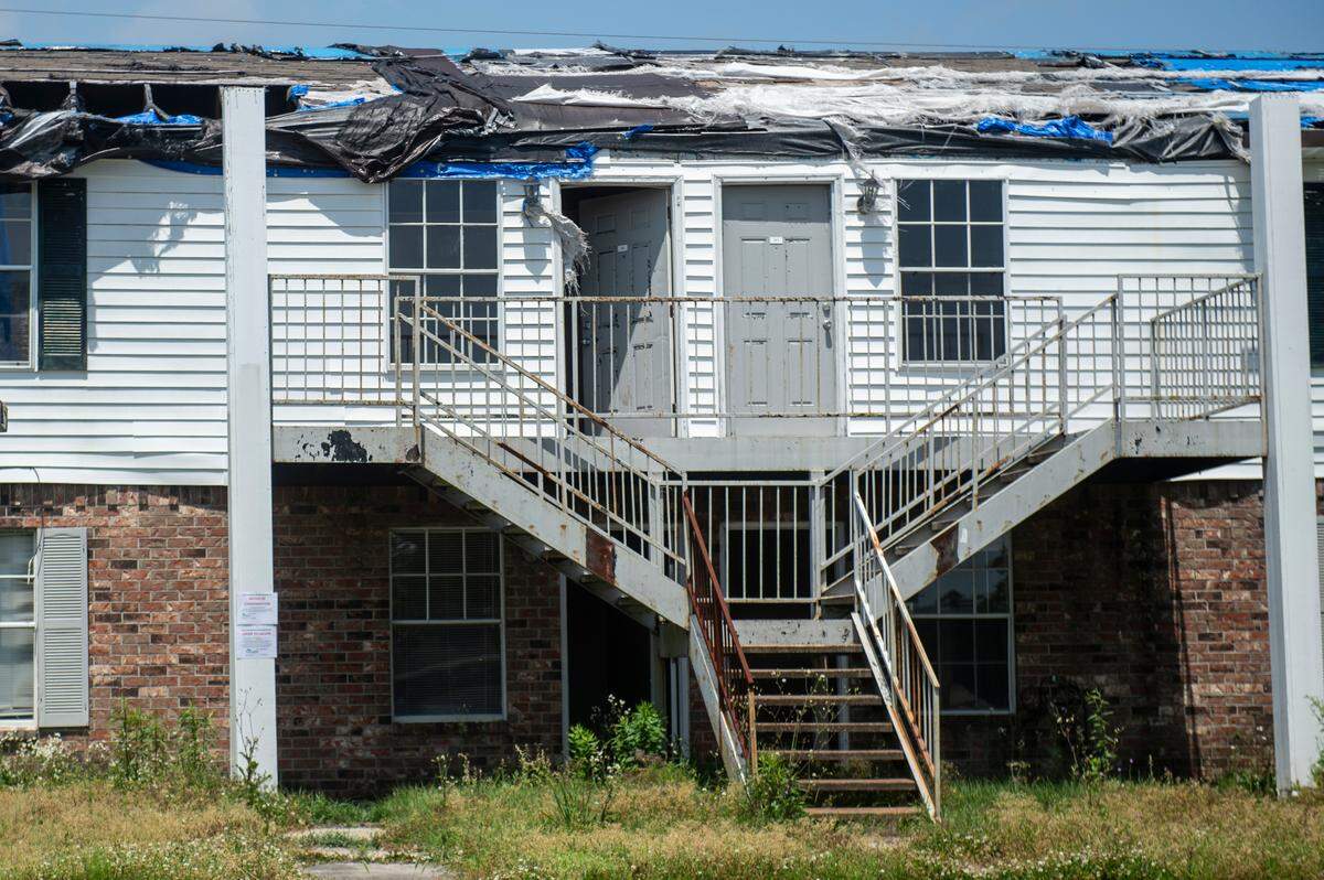 Doors sit ajar on a building with a missing roof at the Gulf Grove Apartments in Waveland on Friday, April 19, 2024. The city of Waveland condemned the apartments over the condition of the buildings and residents will have 30 days to move out.