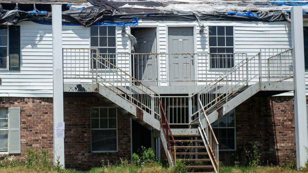 Doors sit ajar on a building with a missing roof at the Gulf Grove Apartments in Waveland on Friday, April 19, 2024. The city of Waveland condemned the apartments over the condition of the buildings and residents will have 30 days to move out.