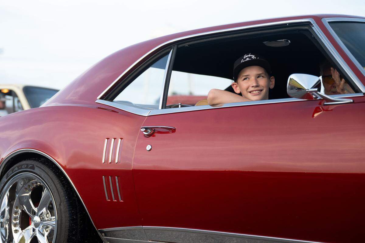 A child smiles from the passenger seat of a vintage car during the Long Beach Cruisin’ The Coast Parade on Monday, October. 6, 2025. The “parade”on Saturday will be along Beach Boulevard as people find a place to watch the cruisers drive by.