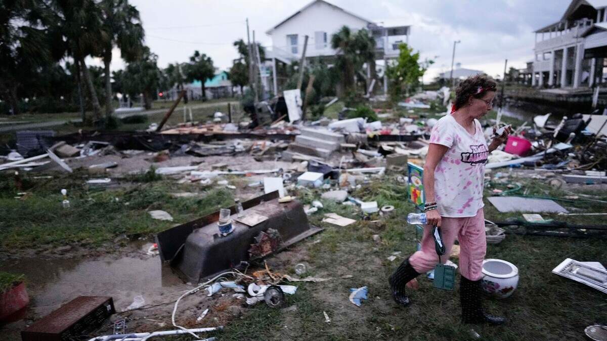 Jewell Baggett walks amidst debris strewn across the yard where her mother’s home had stood, as she searches for anything salvageable in Horseshoe Beach, Fla., after the passage of Hurricane Idalia in 2023.
