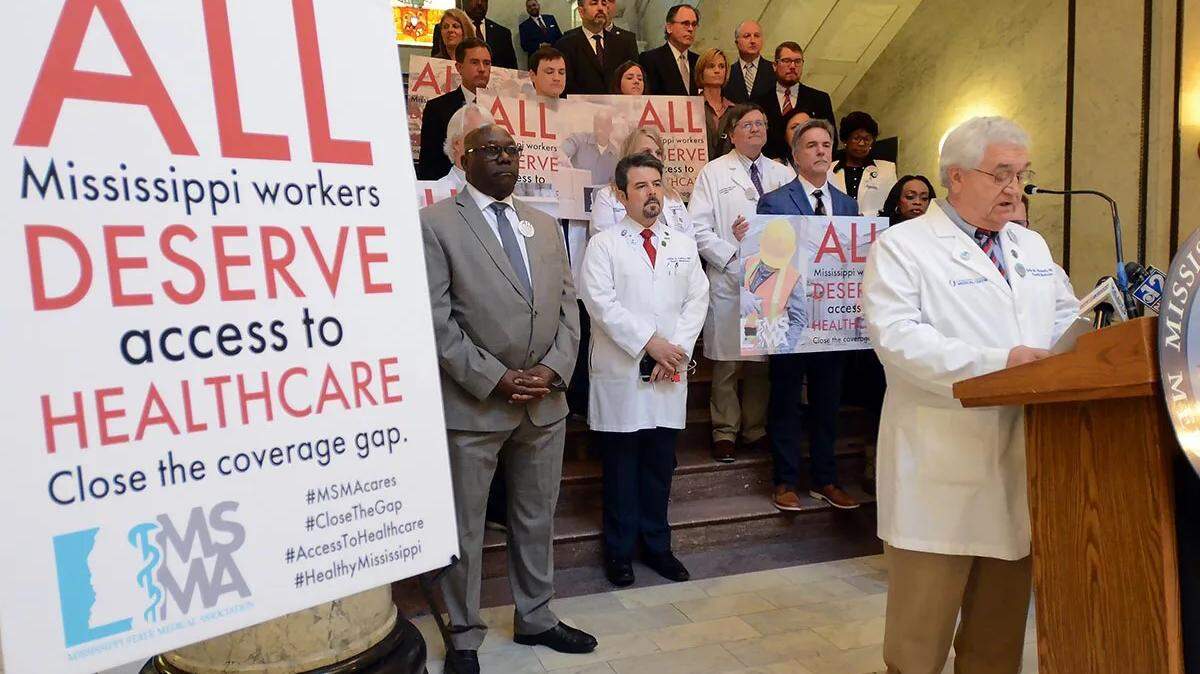 Dr. John Mitchell, Mississippi State Medical Association president, with physicians from across the state, endorses Medicaid expansion and closing the gap in health care coverage, during a press conference on March 21 at the State Capitol in Jackson.