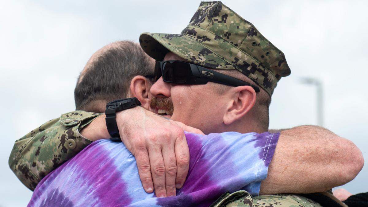 Jared Anton, a member of Naval Mobile Construction Battalion 1, reunites with family as the battalion returns home from deployment on Thursday, March 13, 2025, to Naval Construction Battalion Center Gulfport.