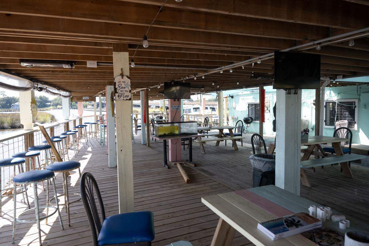 Outdoor seating areas at French Hermit Oyster Co. in Ocean Springs are in the sun or shade and have views of the water.