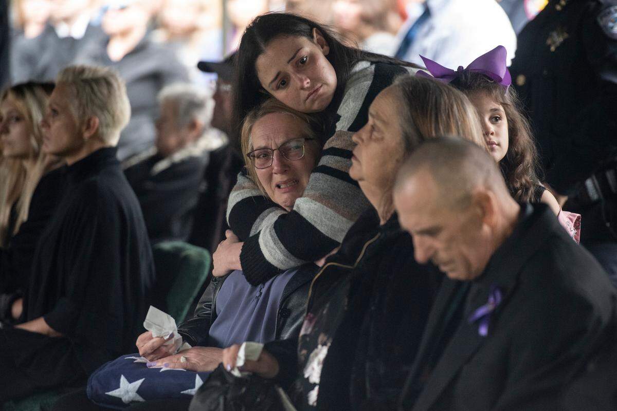 Steven Robin’s family members react during the ceremonies at the gravesite of Bay St. Louis police officers Sgt. Steven Robin and Branden Estorffe at Gardens of Memory cemetery in Bay St. Louis on Wednesday, Dec. 21, 2022. Robin and Estorffe were killed responding to a call at a Motel 6 on Dec. 14.