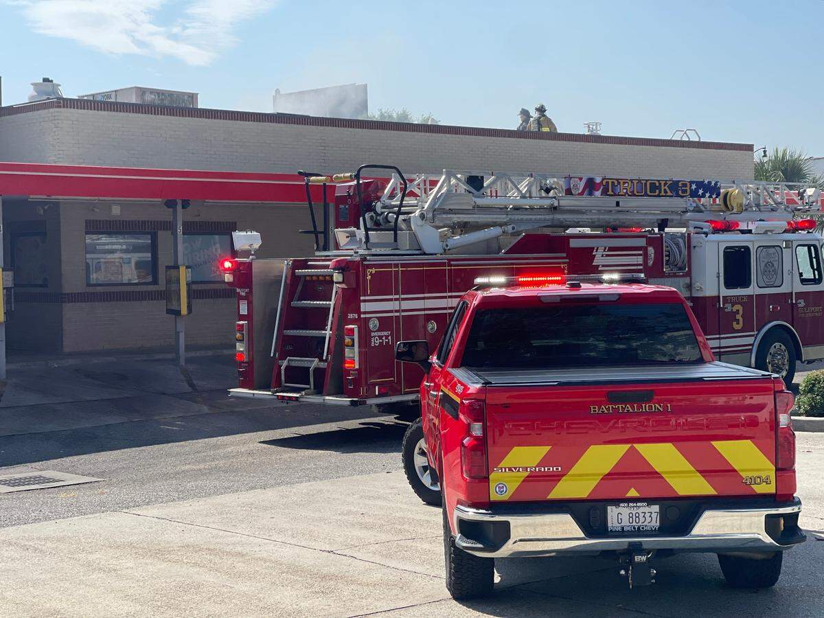 Firefighters climb onto the roof of Sonic Drive-In restaurant off Highway 49 in Gulfport on Thursday, May 25, 2023, after receiving a call about an apparent kitchen fire.