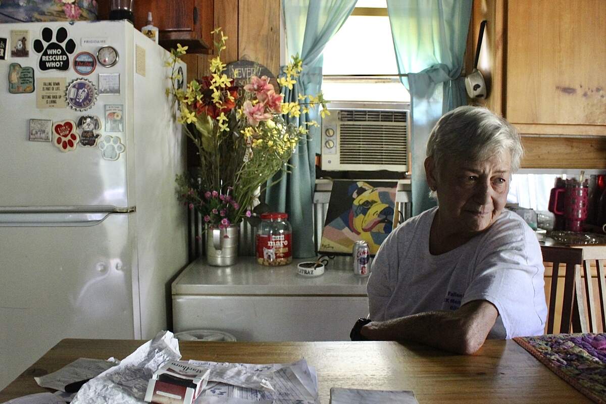 Retired Stone County sheriff’s deputy Phyllis Olds sits at her dining table in her Perkinston home on June 24.