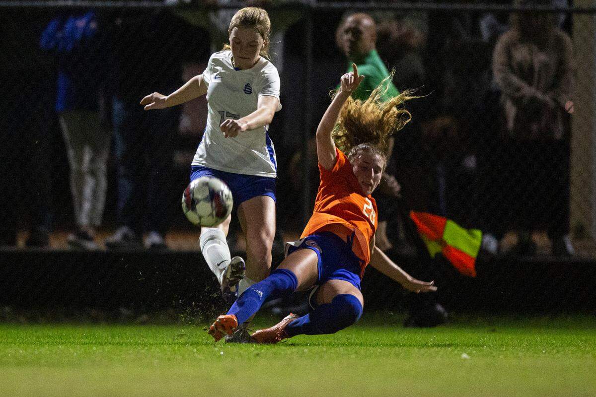 Gulfport’s Mary Frances Symmes slidetackles Ocean Springs’ Kieran Goodman during the 6A South State Championship game in Gulfport on Tuesday, Jan. 31, 2023.