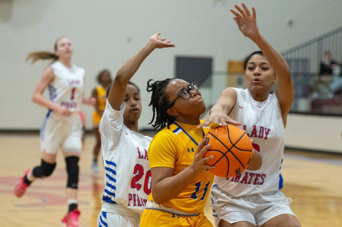 Bay High’s Taniya Lewis gets blocked by Pass Christian during a game against Pass Christian in Pass Christian on Tuesday, Jan. 23, 2024.