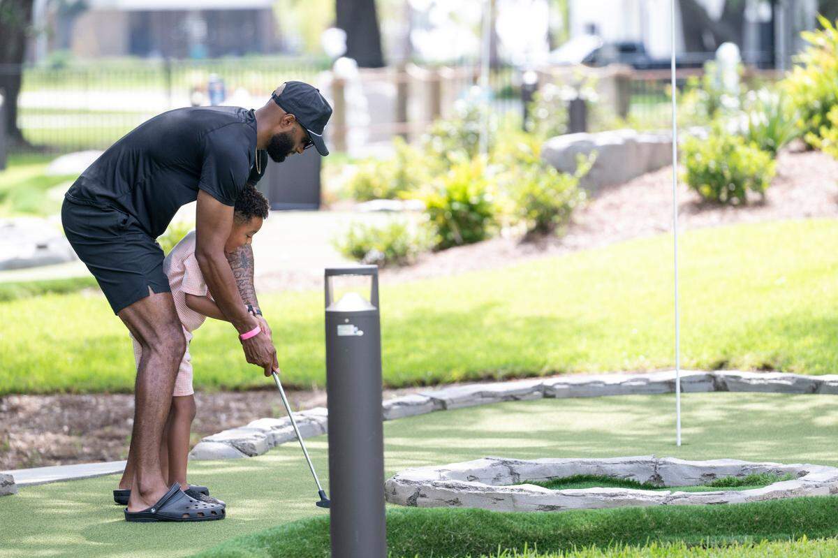 Visitors play mini golf at Hippie Fish at Centennial Plaza in Gulfport on Thursday, June 26, 2025.