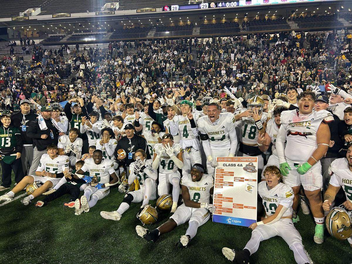 The Poplarville Hornets celebrate after beating Louisville 29-28 to win the 4A state championship game.