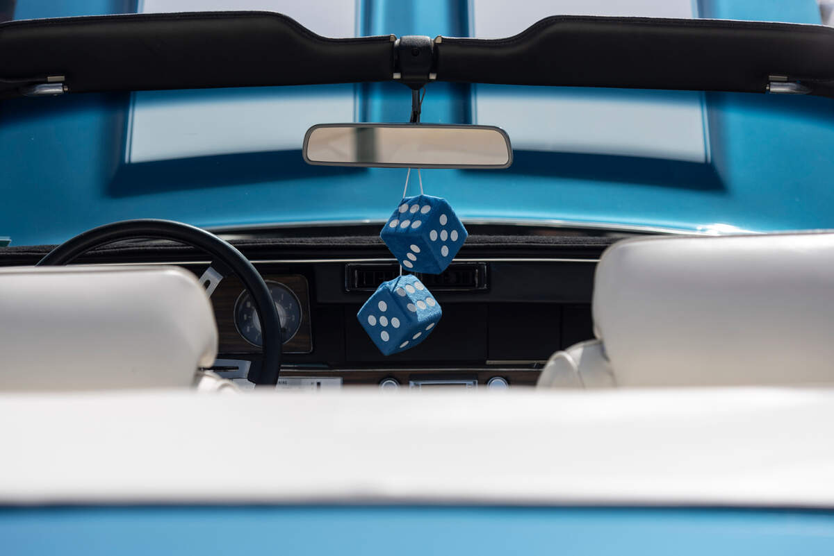 Dice hang from the rear-view mirror of a classic car during Cruisin’ the Coast on Wednesday, Oct. 4, 2023.