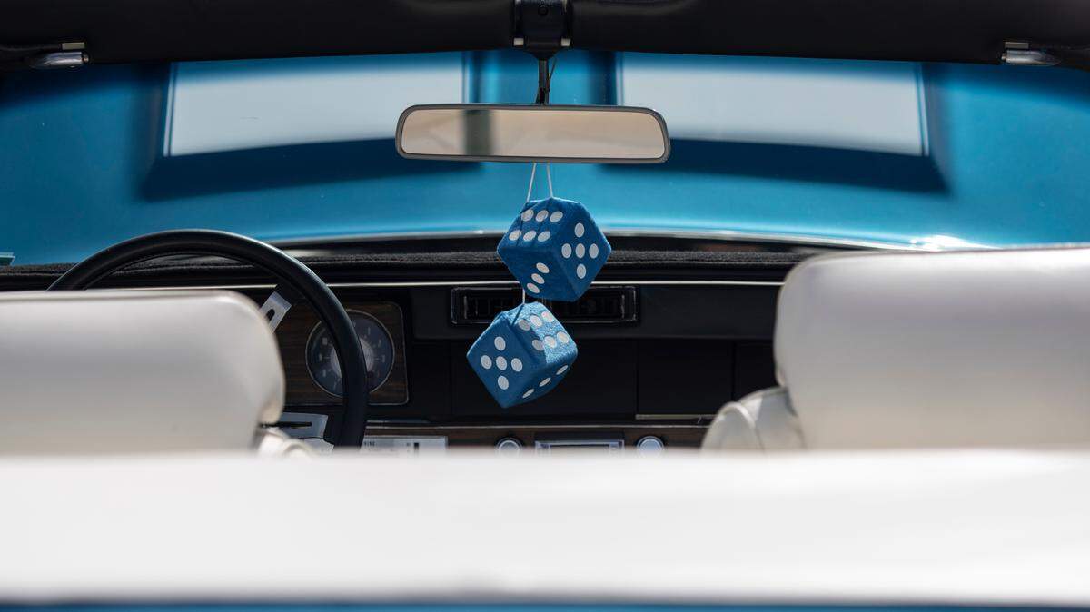 Dice hang from the rear-view mirror of a classic car during Cruisin’ the Coast on Wednesday, Oct. 4, 2023. 