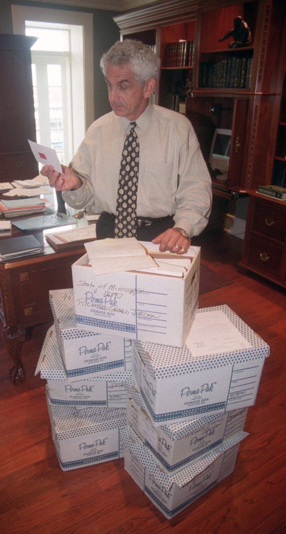 Gulfport attorney Joe Sam Owen, looks over case files from the kidnapping and murder of Edwina Martin by Richard Jordan. Owen has handled the case for over 25 years.