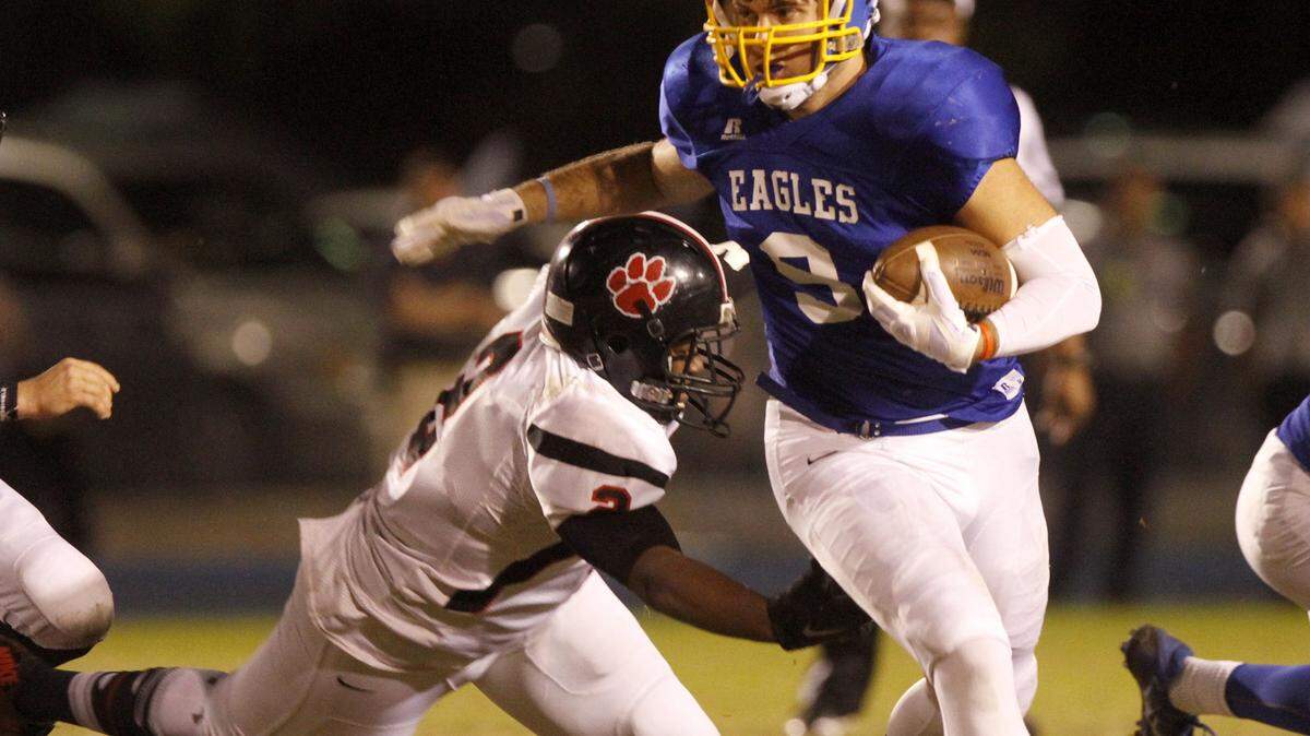 TIM ISBELL/SUN HERALD 
 Resurrection running back Patrick Watt's sheds the attempted tackle of Lumberton's Davion Edwards, Friday, Nov. 27, 2015.