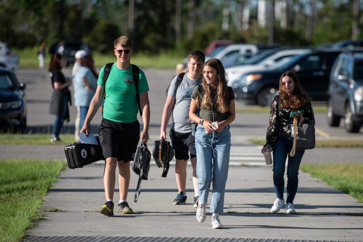 High school students walk to their first class on the first day of school at Ocean Springs High School in Ocean Springs on Friday, Aug. 5, 2022.