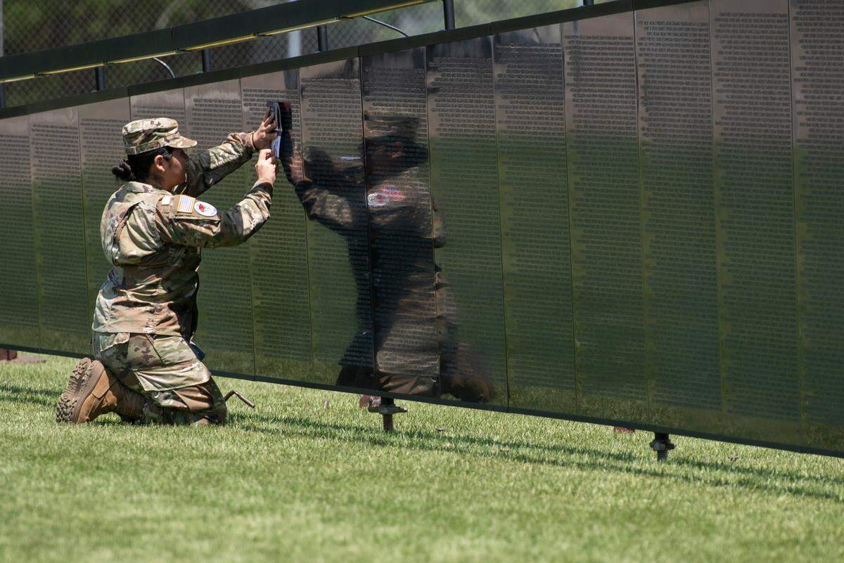 A JROTC member does a rubbing of a name on The Wall That Heals, a traveling three-quarter scale replica of the Vietnam Veterans Memorial in D.C., while it is on display at the D’Iberville Sports Complex in D’Iberville on Thursday, April 10, 2025.