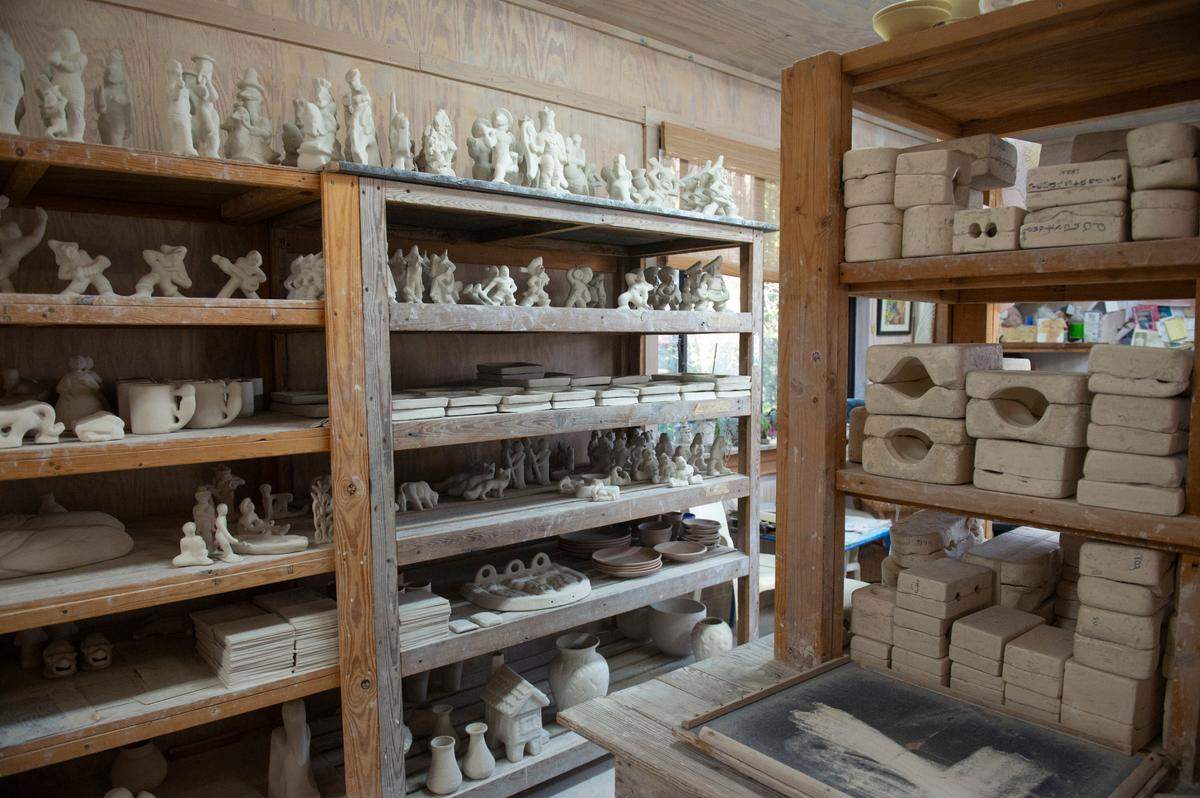 Shearwater pottery pieces that have yet to be glazed are on the shelves at Shearwater Pottery workshop in Ocean Springs.