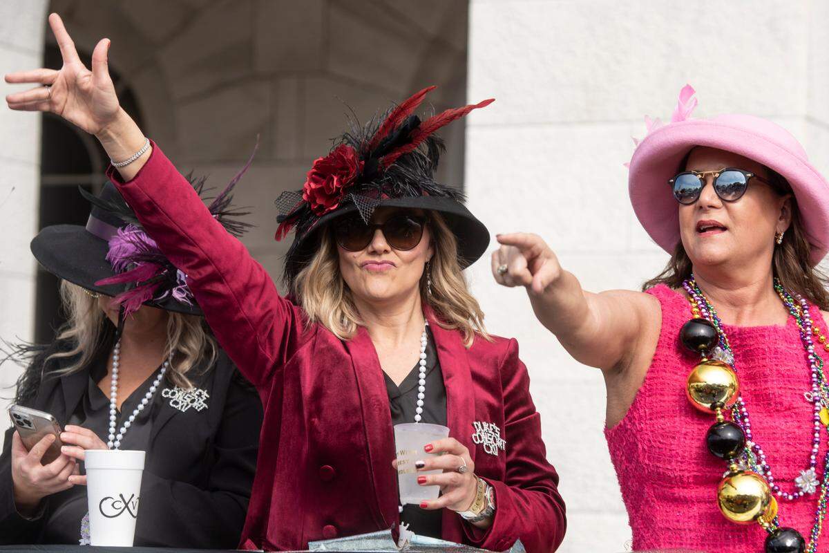 Members of the royal court look for beads to be thrown to them during the Gulf Coast Carnival Association Mardi Gras parade in Biloxi on Tuesday, Feb. 21, 2023.