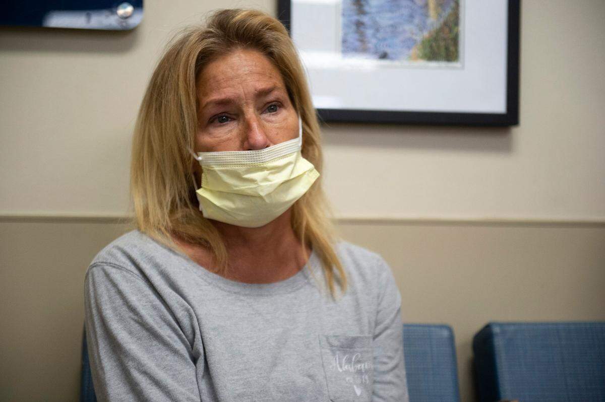 Cherie West, 47, of Theodore waits in the waiting room at the emergency room at Ocean Springs Hospital in Ocean Springs on Tuesday, Aug. 17, 2021. West came to the hospital with COVID-19 like symptoms.