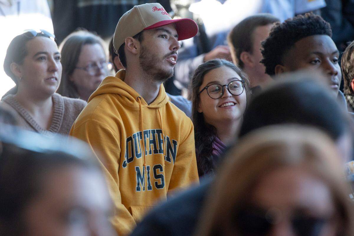 Fans listen as Southern Miss’ new head football coach Charles Huff makes an introductory speech during a public welcome celebration for Huff at The Rock in Hattiesburg on Thursday, Dec. 12, 2024.