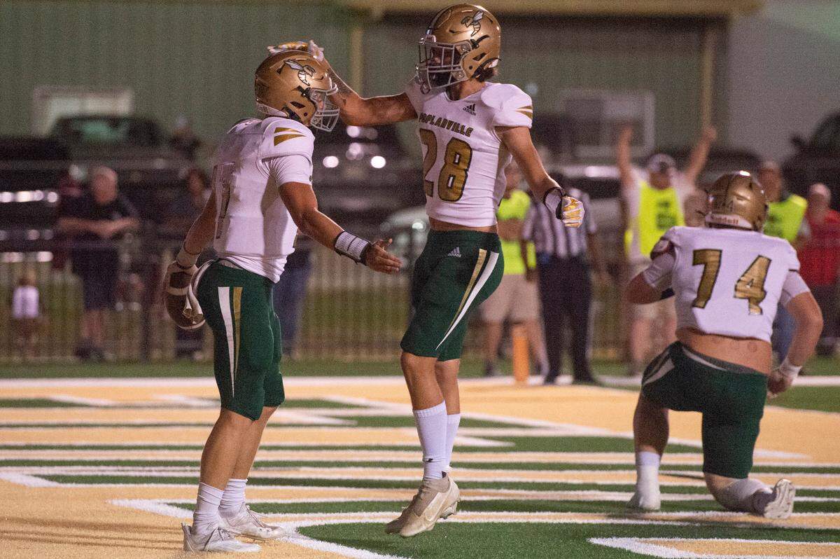 Poplarville’s Levi Jones (#28) congratulates quarterback Matt Will after his touchdown during a game against Lawrence County at Poplarville High School in Poplarville on Friday, Oct. 7, 2022.