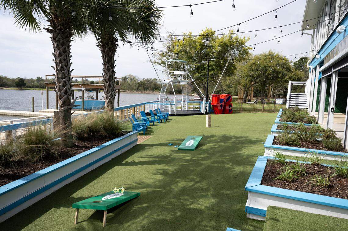 An outdoor games area with corn hole and Jenga towers awaits at Bacchus on the Bluff in Gulfport.