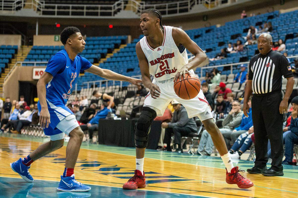 Harrison Central forward Sam Murray defends the ball from Pass Christian’s LJ Jaynes Jr. during Hoopsfest at the Mississippi Coast Coliseum in Biloxi on Saturday, Jan. 29, 2022.