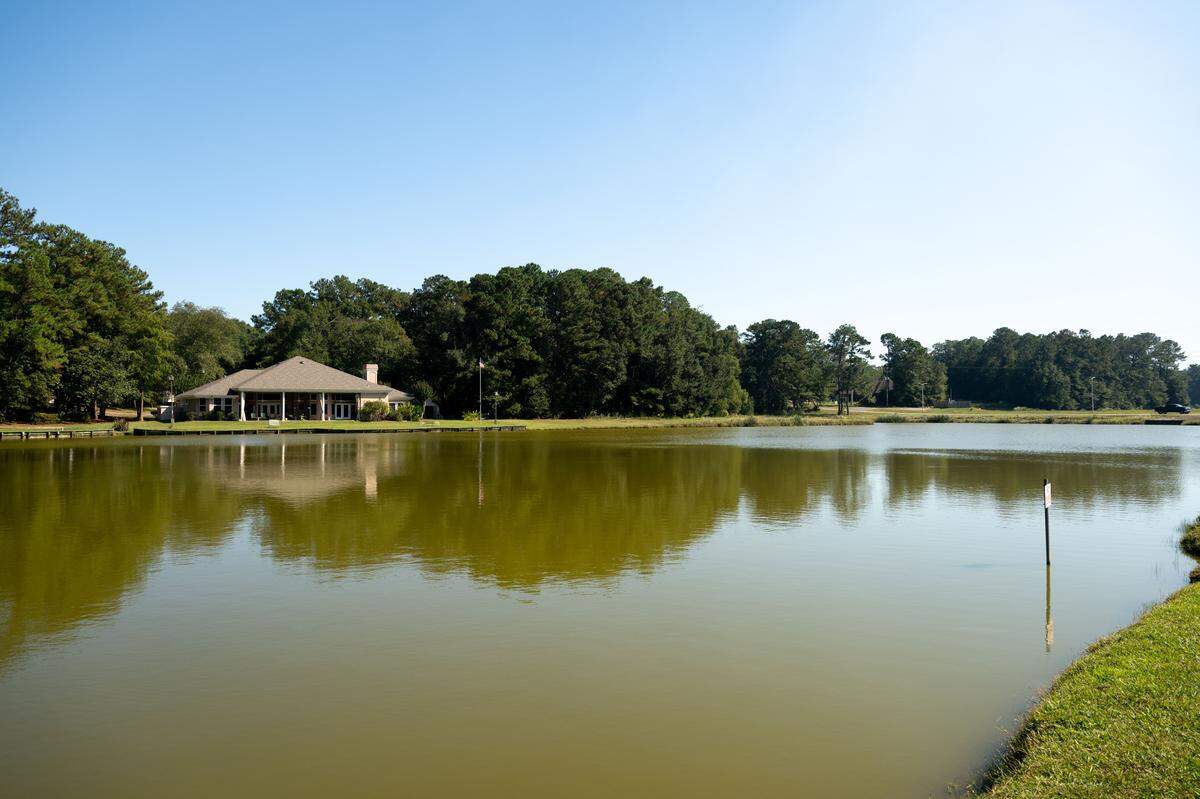 A house sits on a lake in Diamondhead on Tuesday, Oct. 14, 2025. The area, known as Twin Lakes, includes a walking trail, disk golf and pavilion. It is owned and operated by the Diamondhead Property Owners Association.