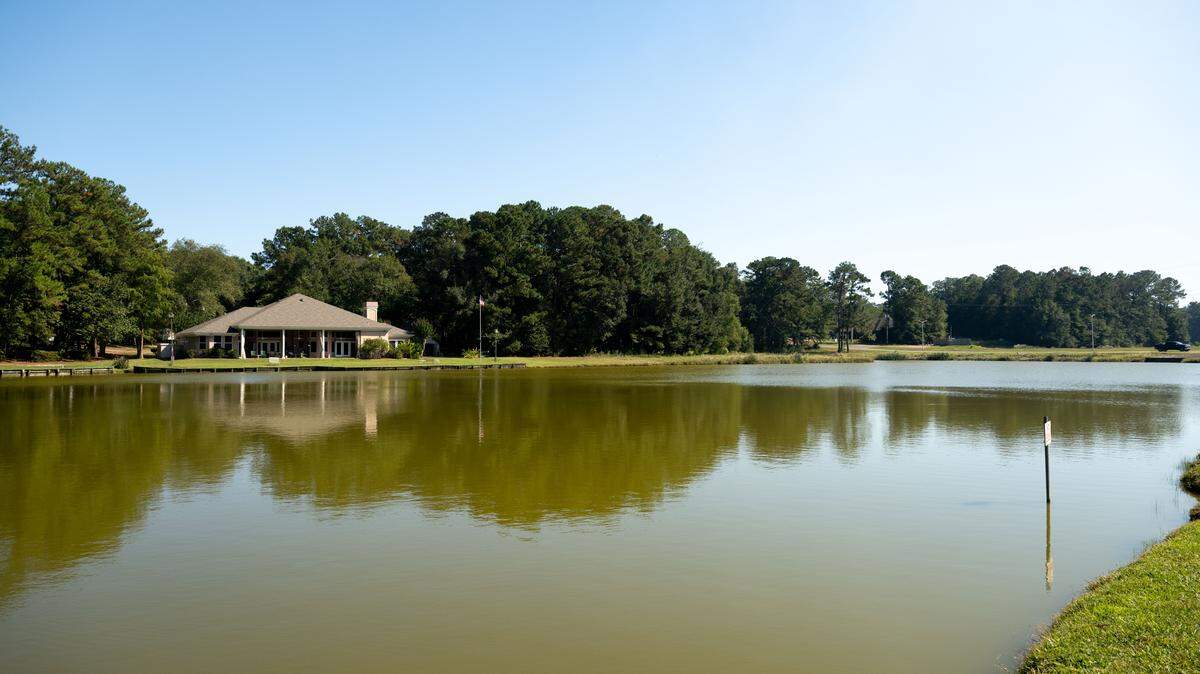 A house sits on a lake in Diamondhead on Tuesday, Oct. 14, 2025. The area, known as Twin Lakes, includes a walking trail, disk golf and pavilion. It has long been owned and operated by the Diamondhead Property Owners Association but will soon be transferred to the city as the POA confronts financial challenges.