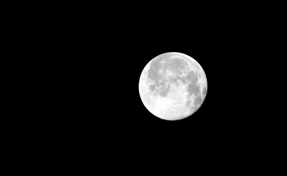 TIM ISBELL/SUN HERALDThe Strawberry Moon provides illumination for the Saturn V rocket to arrive at Infinity Science Center, Monday, June 20, 2016.