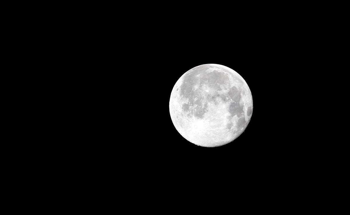 TIM ISBELL/SUN HERALDThe Strawberry Moon provides illumination for the Saturn V rocket to arrive at Infinity Science Center, Monday, June 20, 2016.
