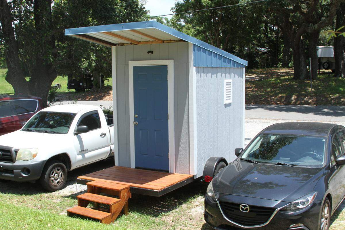 The exterior of an emergency tiny home prototype on wheels parked outside Back Bay Mission in Biloxi. More cities are turning to tiny homes as temporary shelters for people experiencing homelessness.