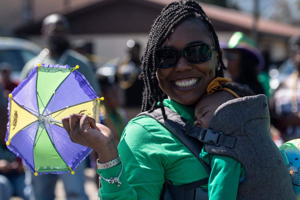 A member of a marching group poses during the Jackson County Carnival Association Mardi Gras parade in Pascagoula on Saturday, March 1, 2025.
