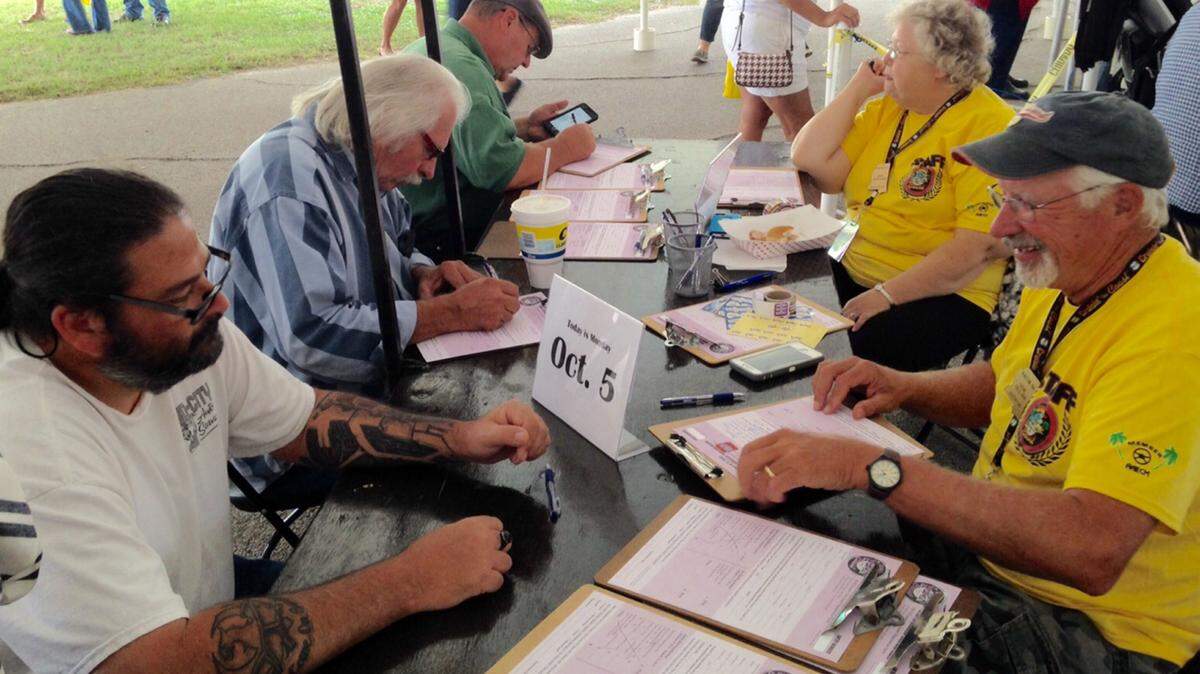 MASKED CRUISER/SUN HERALD 
 Cruisin' The Coast staffers register cruisers at Cruise Central in Gulfport on Monday, Oct. 5, 2015.