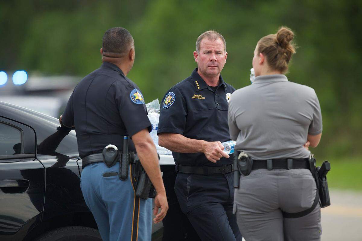 Harrison County Sheriff Matt Haley, center, and other law enforcement officers from across South Mississippi were on the scene at West Harrison High School Thursday, May 16, 2024, after a 911 caller claimed to be in the school with a gun.