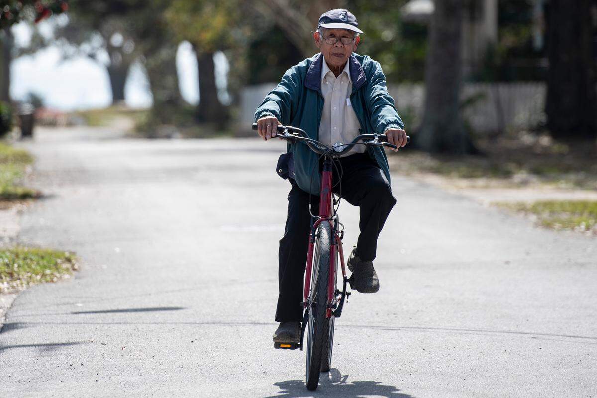 Sinh Nguyen, 76, rides a new bike gifted to him by college student Kevin Tran who started a GoFundMe to get Nguyen a new bike at Biloxi Bicycle Works on Wednesday, Feb. 23, 2022.