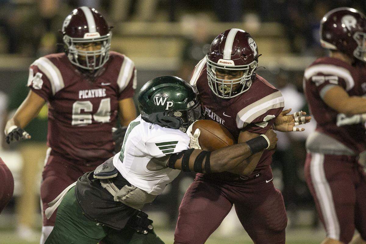 Picayune’s Dante Dowdell gets tackled during the 5A State Championship game at M.M. Roberts Stadium in Hattiesburg on Saturday, Dec. 4, 2021.